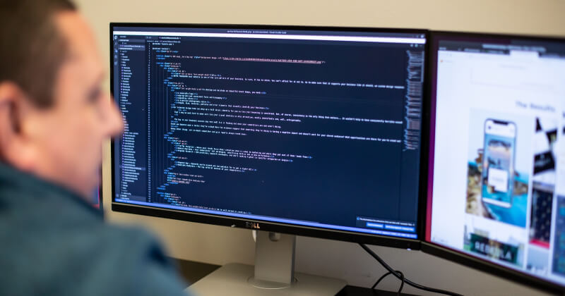 A developer workiing on a website at their computer