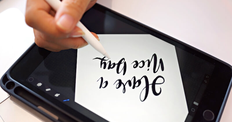 A designer drawing on a computer tablet.